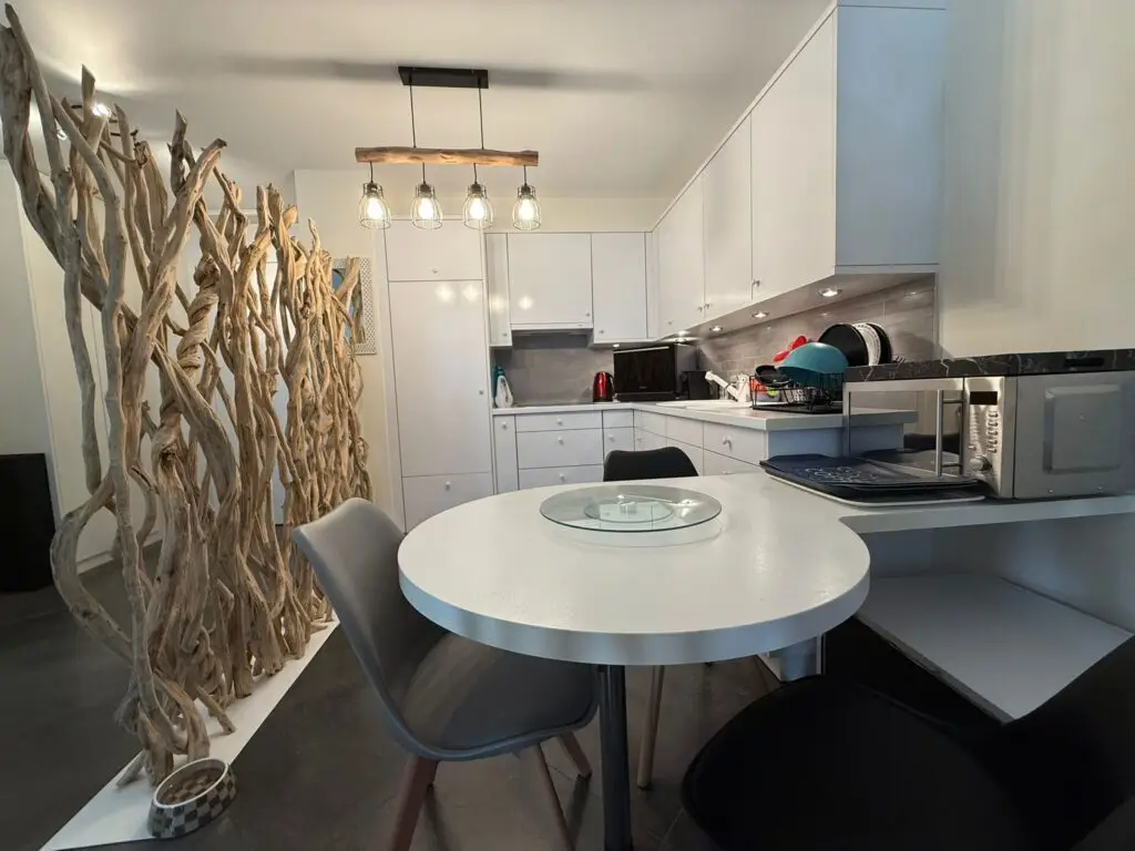 Modern white kitchen in one-bedroom apartment for sale, Grand Rue, Montreux, Switzerland