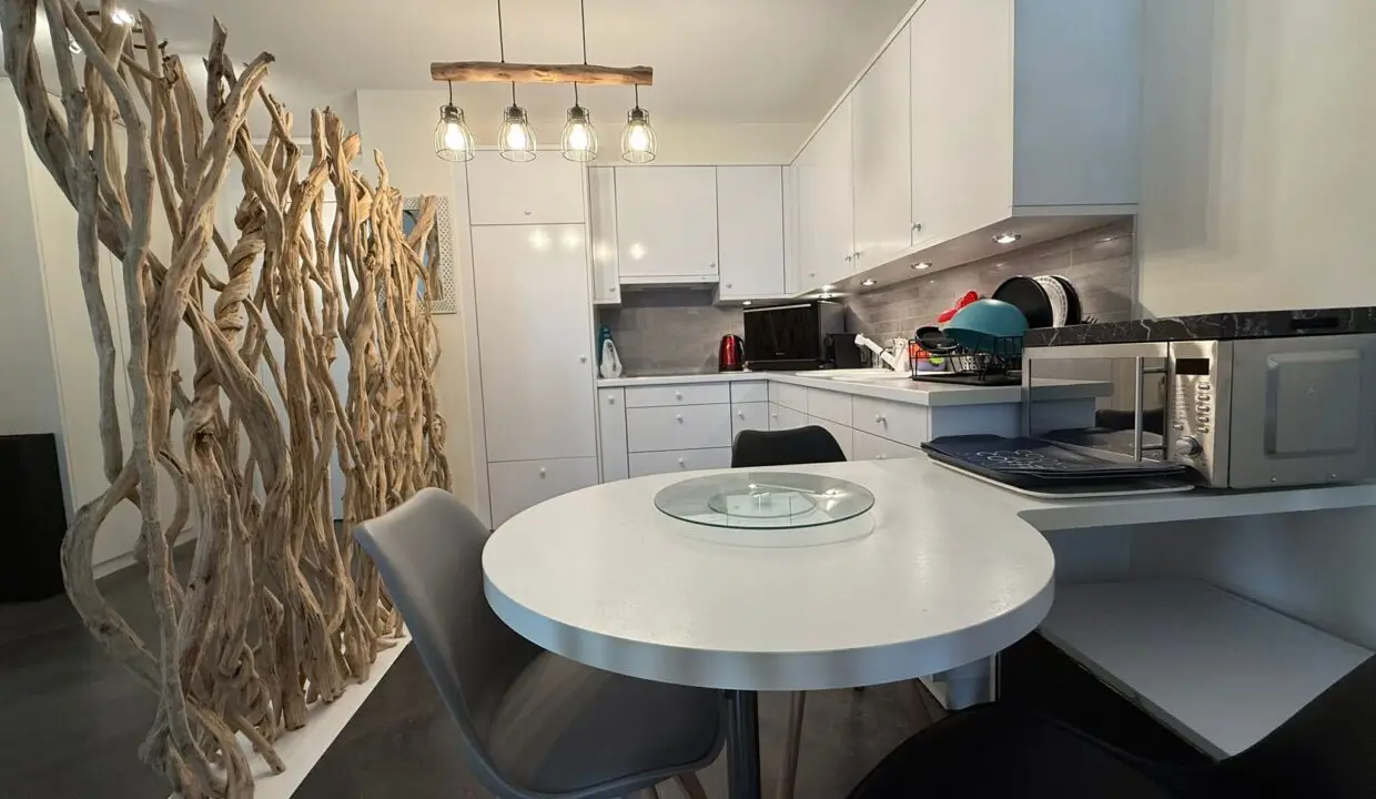 Modern white kitchen in one-bedroom apartment for sale, Grand Rue, Montreux, Switzerland