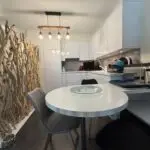 Modern white kitchen in one-bedroom apartment for sale, Grand Rue, Montreux, Switzerland