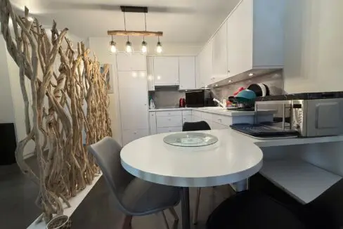 Modern white kitchen in one-bedroom apartment for sale, Grand Rue, Montreux, Switzerland