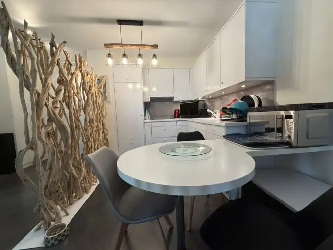Modern white kitchen in one-bedroom apartment for sale, Grand Rue, Montreux, Switzerland