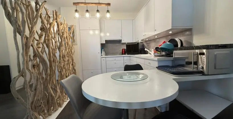 Modern white kitchen in one-bedroom apartment for sale, Grand Rue, Montreux, Switzerland